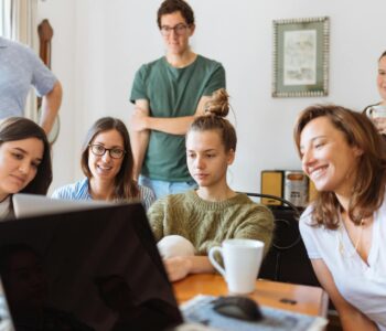 people looking at laptop computer