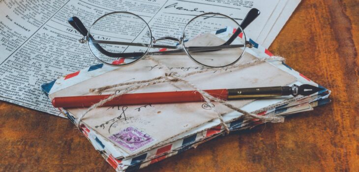 letters and an eyeglass on table