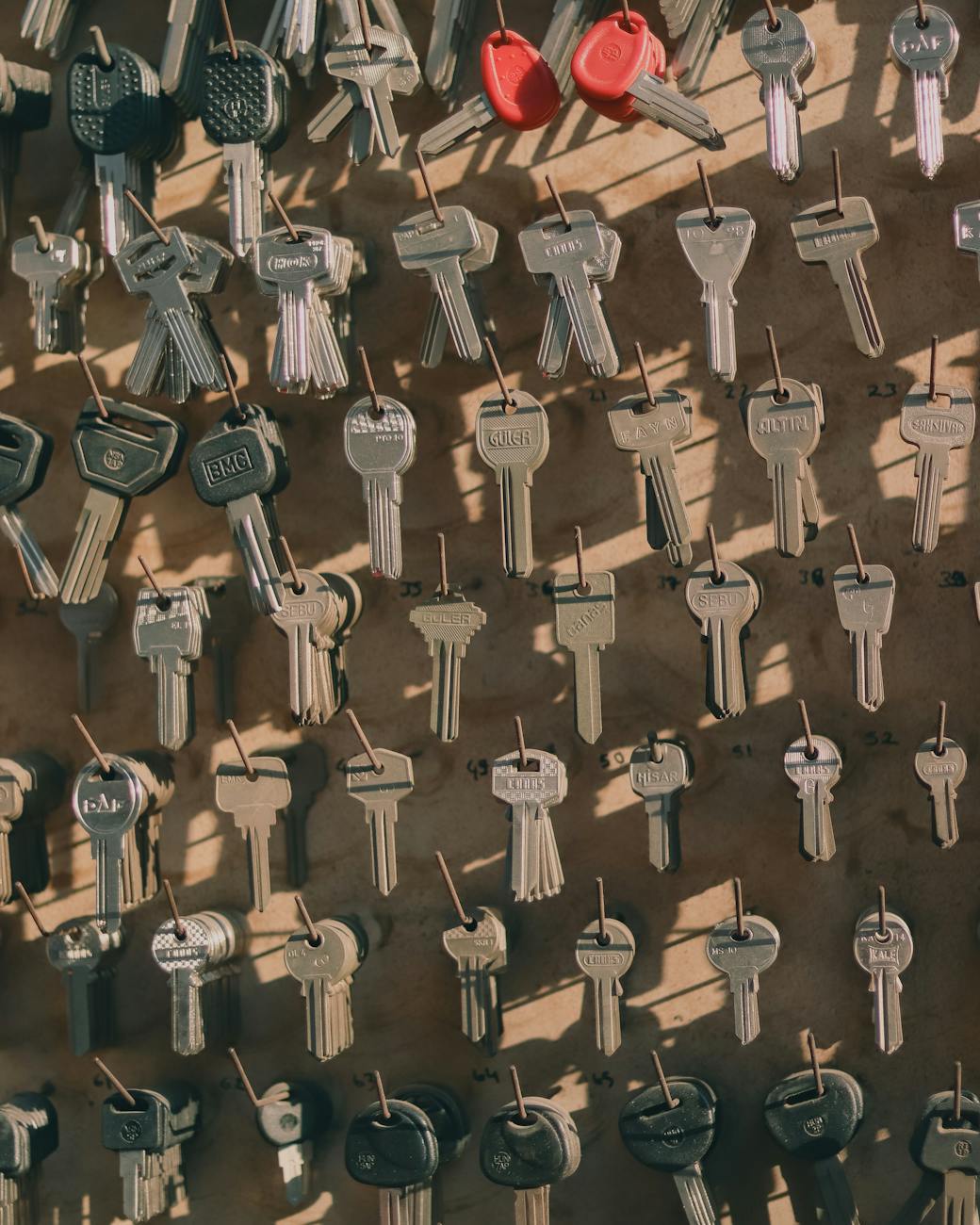 a variety of keys hanging on hooks