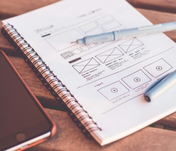 notebook beside the iphone on table