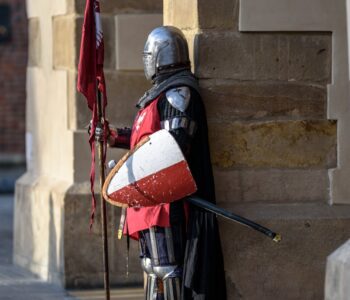 man wearing gray and red armour standing on the streets