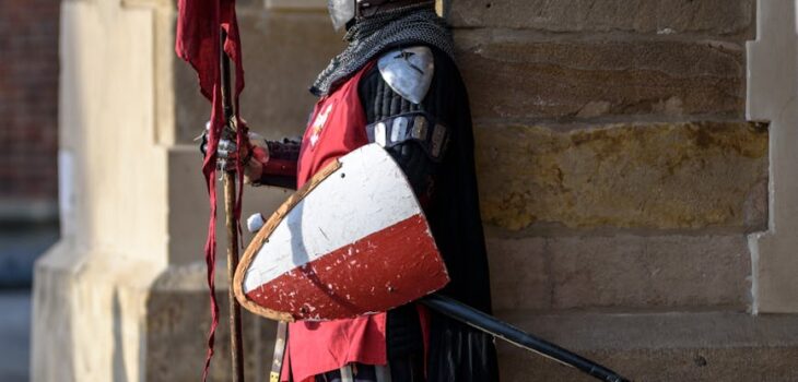 man wearing gray and red armour standing on the streets
