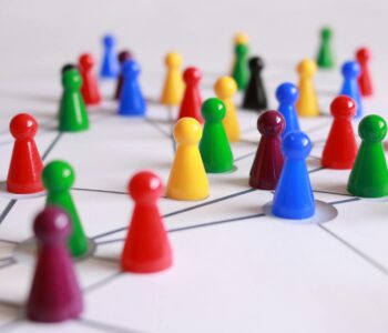 close up photography of yellow green red and brown plastic cones on white lined surface
