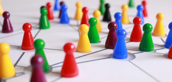 close up photography of yellow green red and brown plastic cones on white lined surface